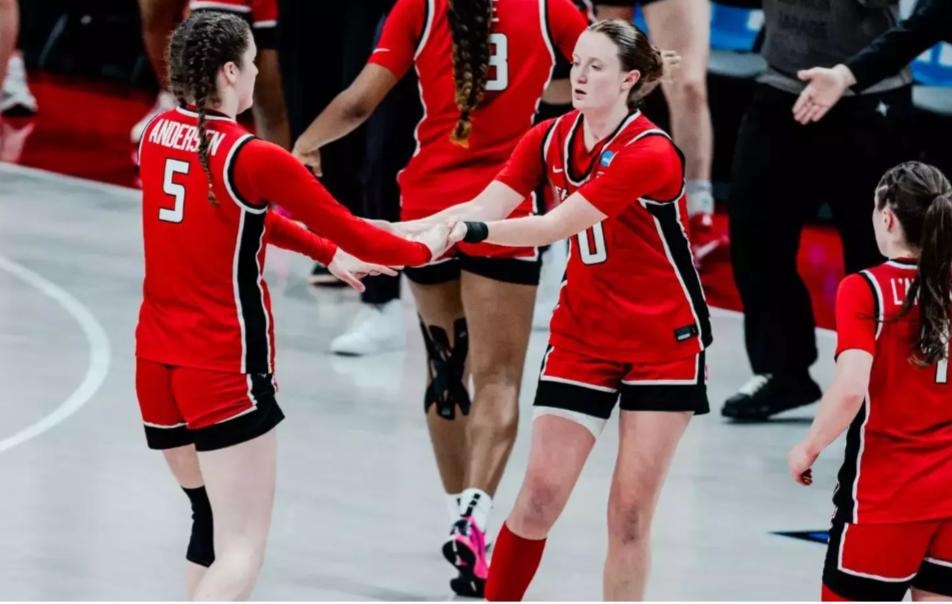 Fairfield players in red uniforms celebrating on court