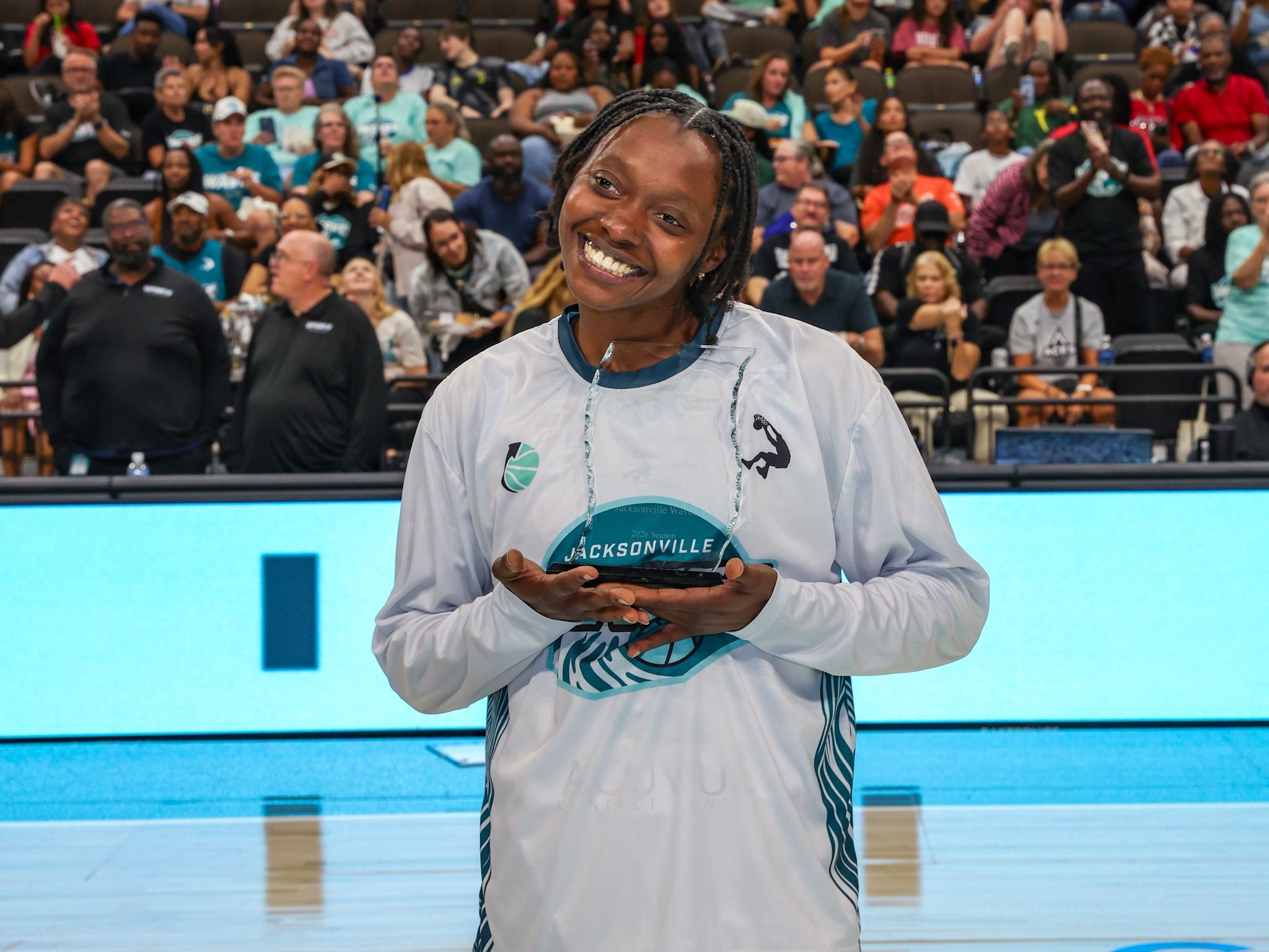 Ariel Hearn holding the inaugural UpShot League MVP award at VyStar Veterans Memorial Arena